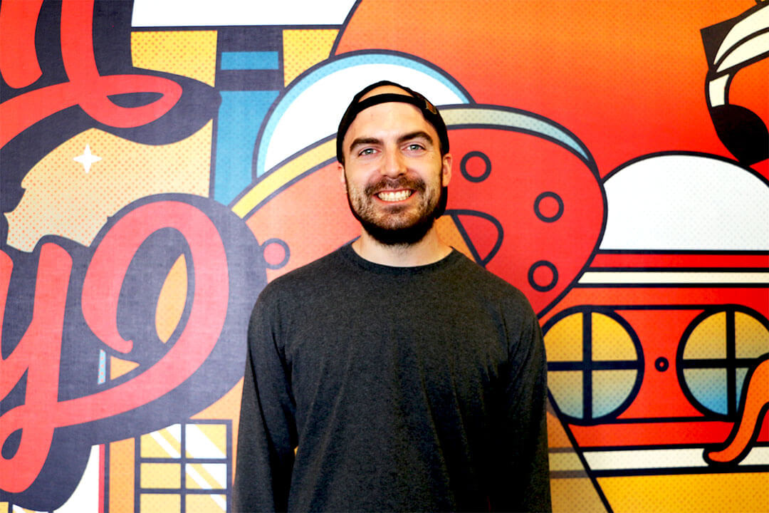 An image of Missouri entrepreneur Seth Kitchen in front of the mural wall at efactory in Sprigfield Missouri.