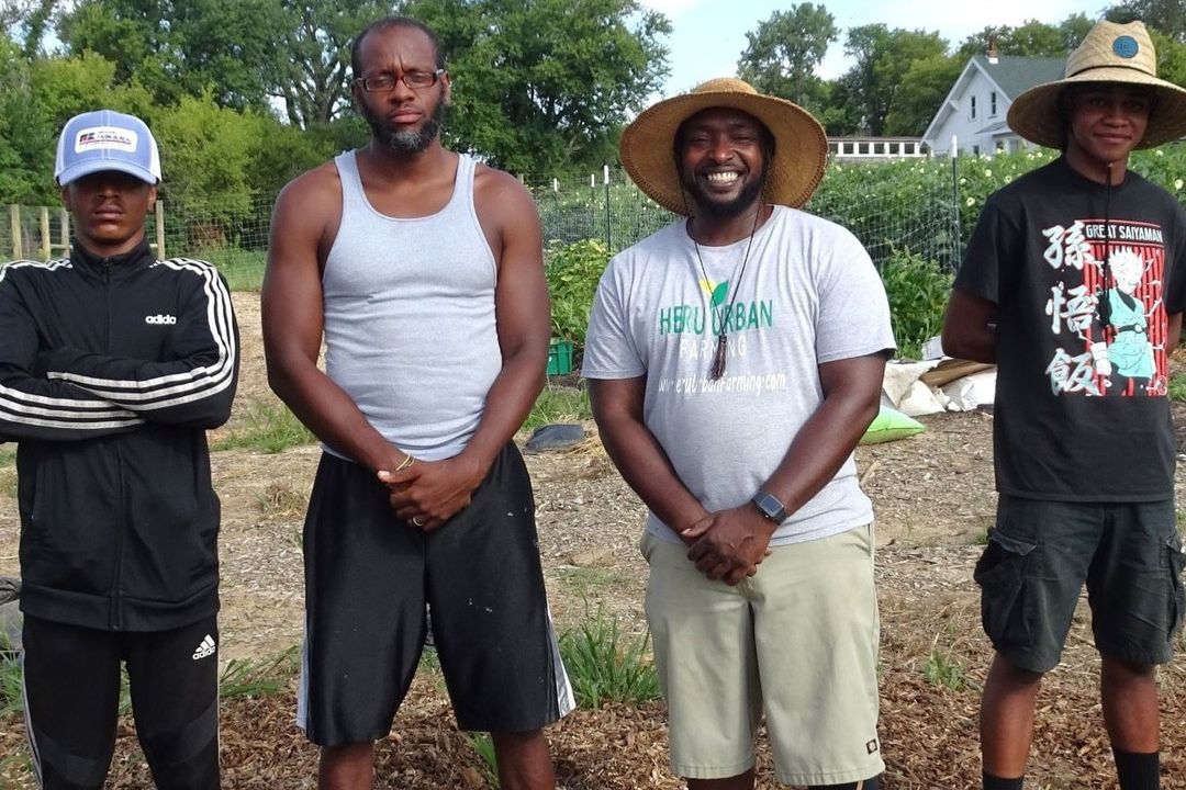 Tyrean Lewis (center right) poses with his coworkers on his urban farm.